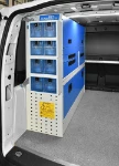 02_Drawers, enclosed shelves and a cabinet of transparent plastic containers in the VW Caddy
