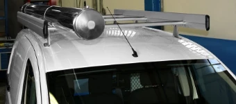 A Partner’s roof rack with a pipe carrier